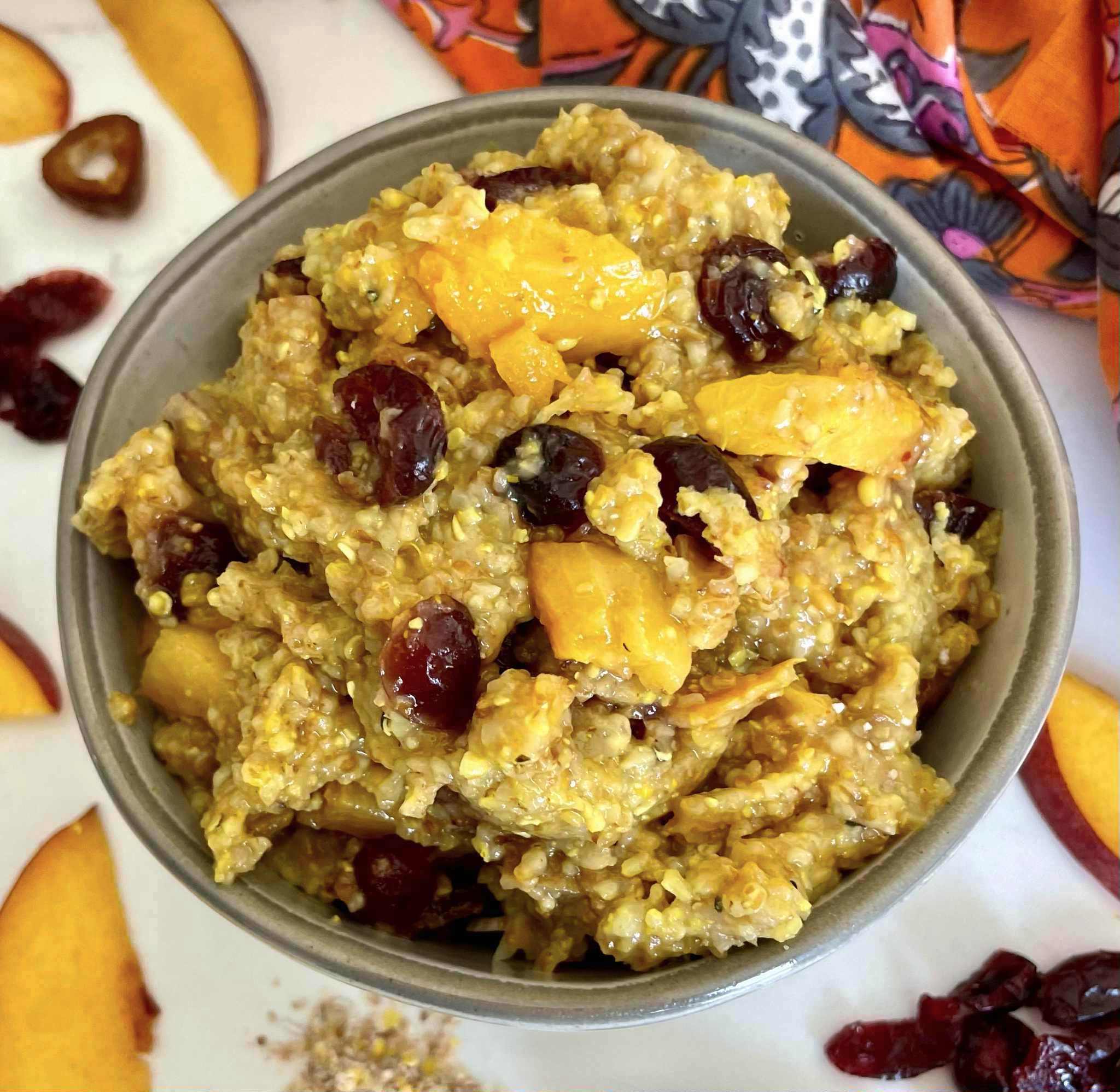 Multigrain Hot Cereal Bowl with Peaches, Dried Cranberries, Dates and Turmeric